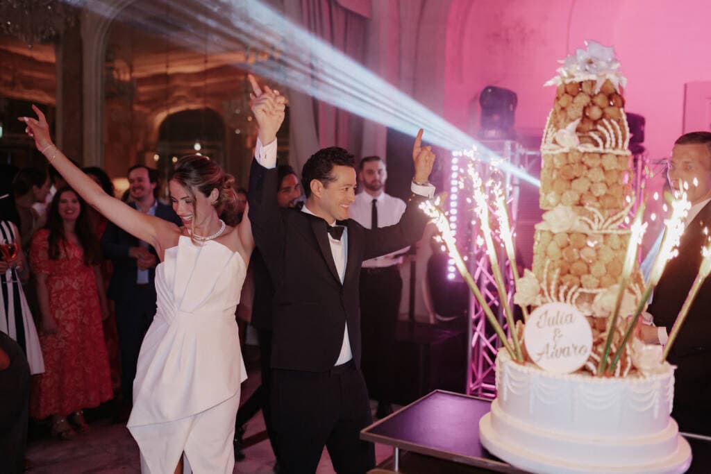 Bride and groom celebration with traditional French croquembouche wedding cake in Paris